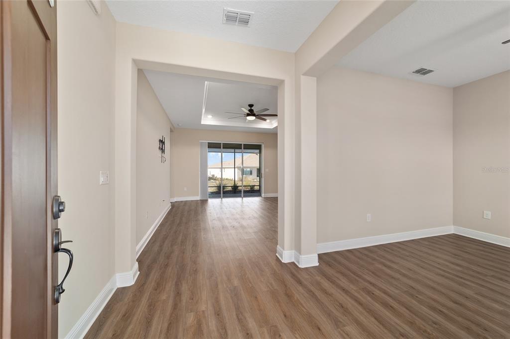9778 Southwest 103rd Avenue Ocala, FL 34481 - Photo 10 of 57 a view of an empty room with wooden floor and a window