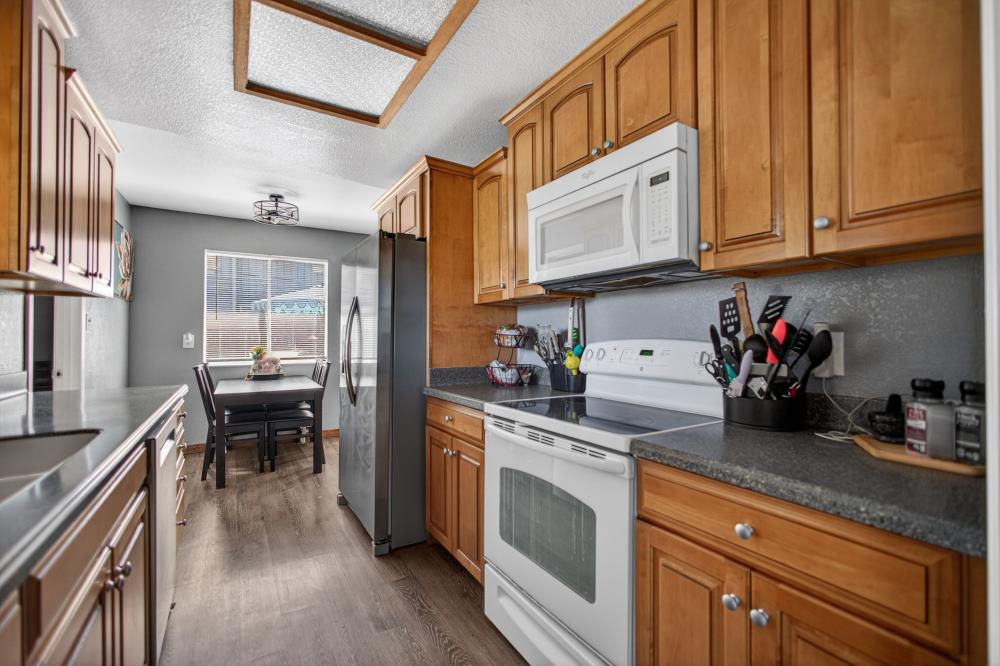 724 Dabney Avenue Rio Linda, CA 95673 - Photo 15 of 53 a kitchen with stainless steel appliances granite countertop a stove a sink and a refrigerator