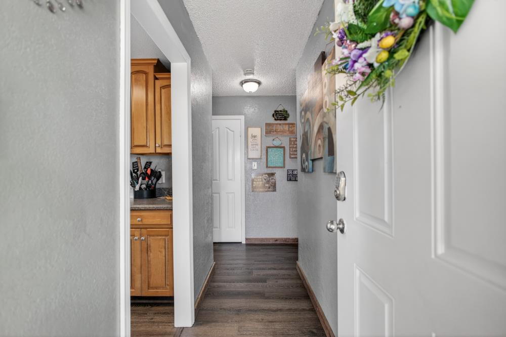 724 Dabney Avenue Rio Linda, CA 95673 - Photo 9 of 53 a view of a hallway with wooden floor and a potted plant
