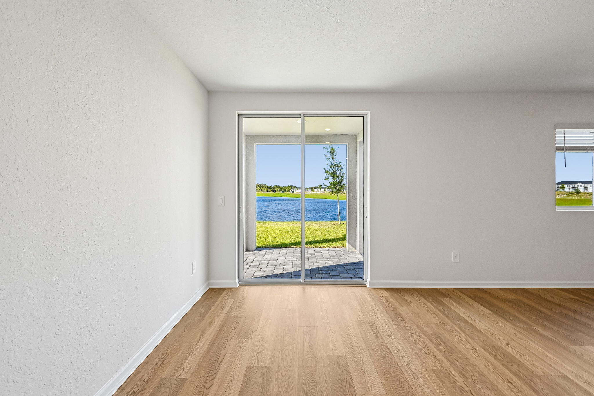 14503 Southwest New Dawn Road Indiantown, FL 34956 - Photo 9 of 42 a view of an empty room and window