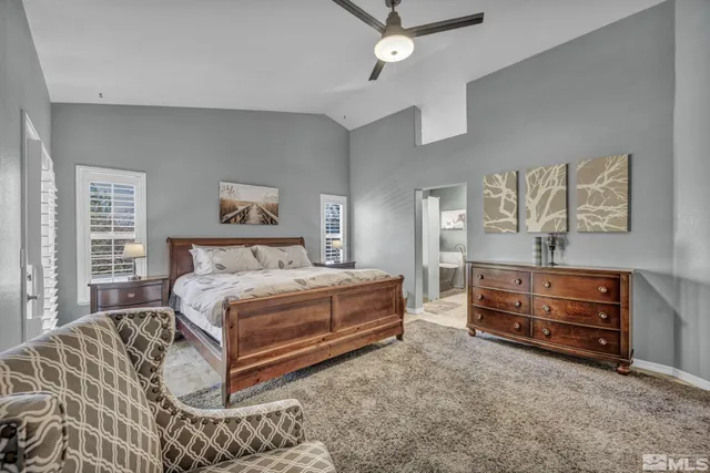 a spacious bedroom with a bed and a dresser