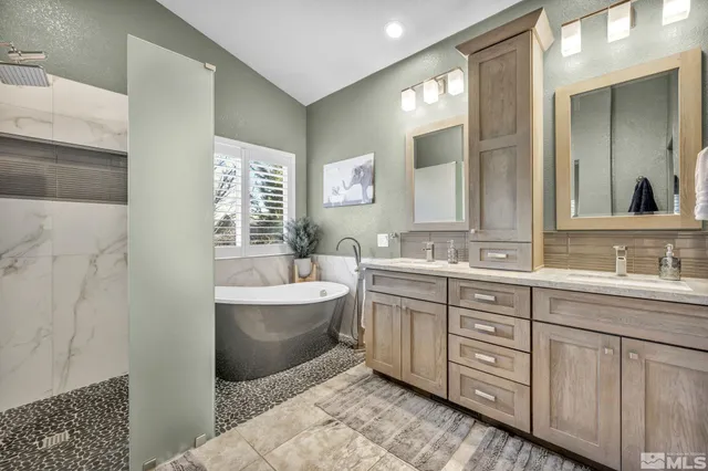 a spacious bathroom with a double vanity sink a mirror and a bathtub