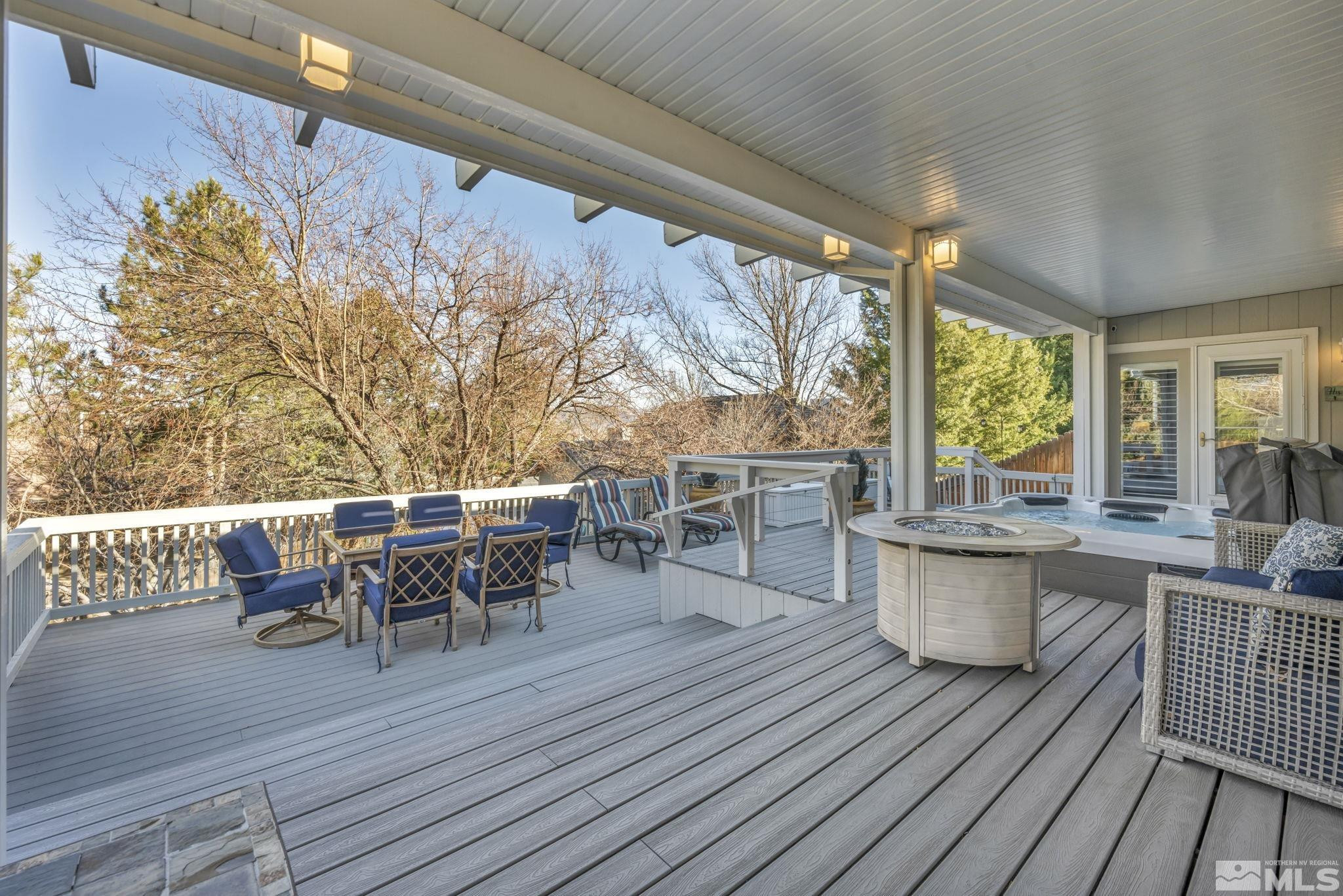 6500 Brookview Circle Reno, NV 89519 - Photo 23 of 24 a view of a roof deck with table and chairs couches with wooden floor and fence