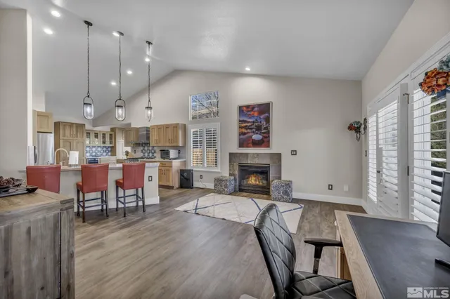 a living room with fireplace furniture and a wooden floor