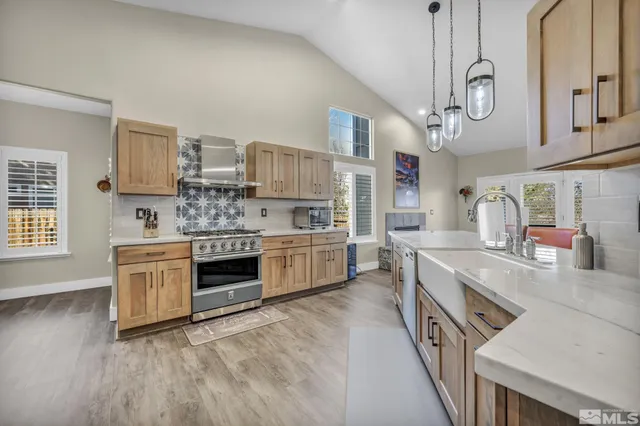a kitchen with stainless steel appliances granite countertop a stove and a sink