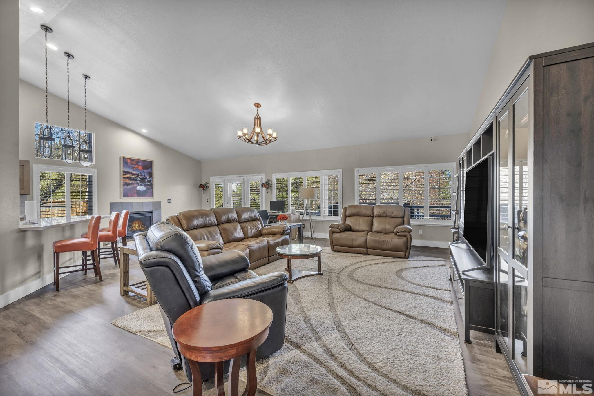 6500 Brookview Circle Reno, NV 89519 - Photo 8 of 24 a living room with furniture a chandelier a rug and a window