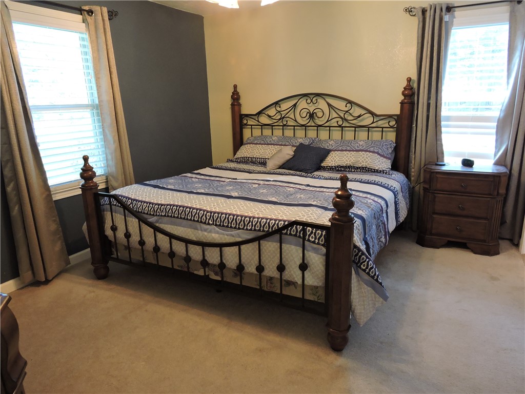 1901 Hattons Ford Road Townville, SC 29689 - Photo 19 of 33 A restful chamber with twin windows and soft carpeting provides a comfortable retreat.