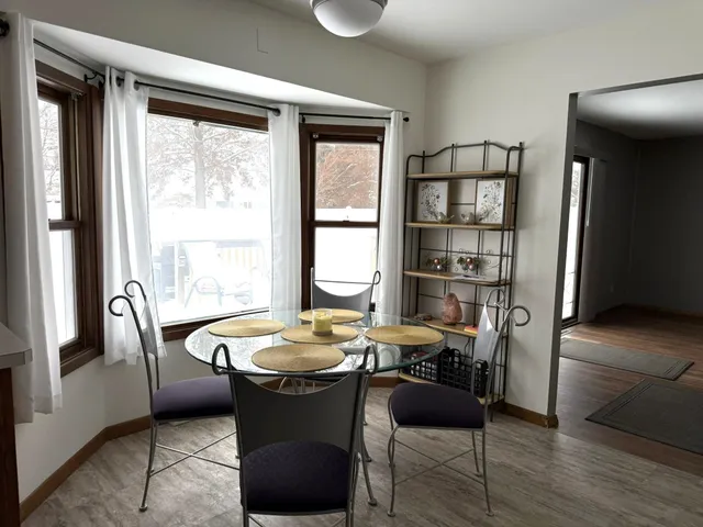 a dining room with furniture and window