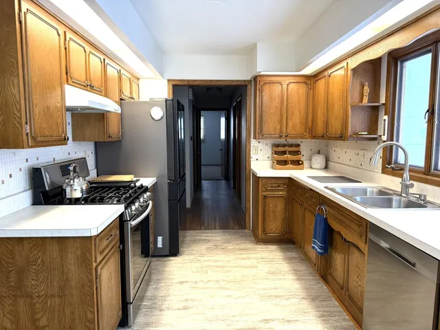 a kitchen with a sink stove and refrigerator