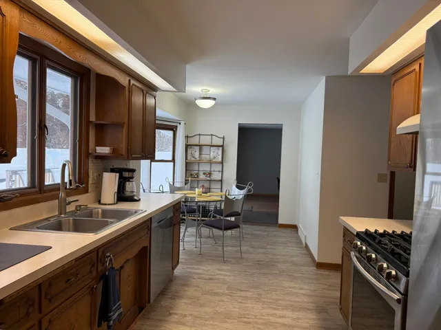 a kitchen with stainless steel appliances granite countertop a sink stove and cabinets