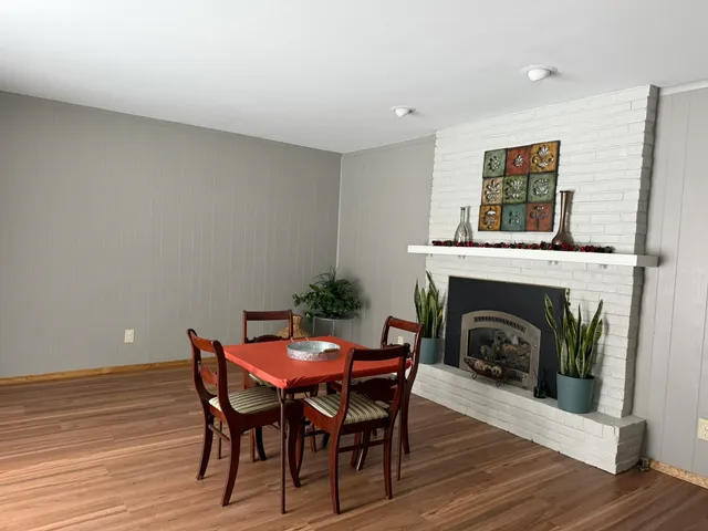 a view of a dining room with furniture and wooden floor