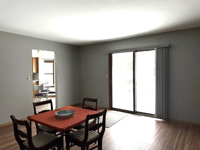a view of a dining room with furniture and window