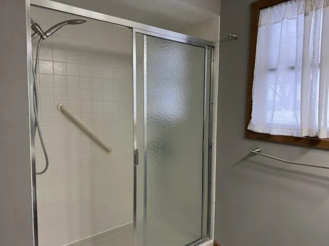 a bathroom with a glass shower door