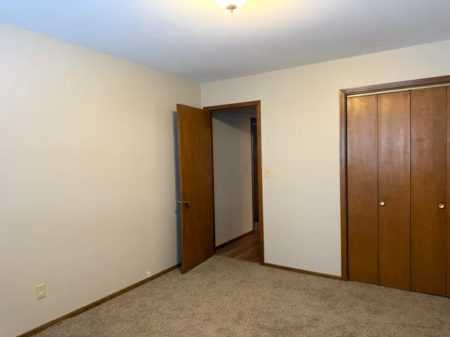 an empty room with closet area