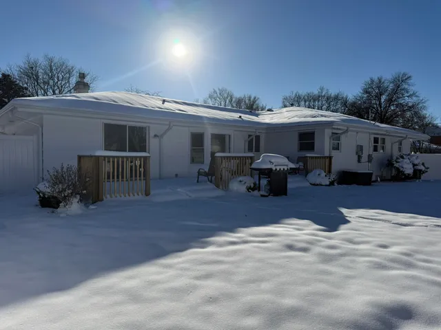 a view of a patio with table and chairs with wooden fence and plants