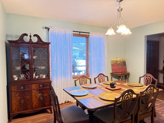 a view of a dining room with furniture and chandelier