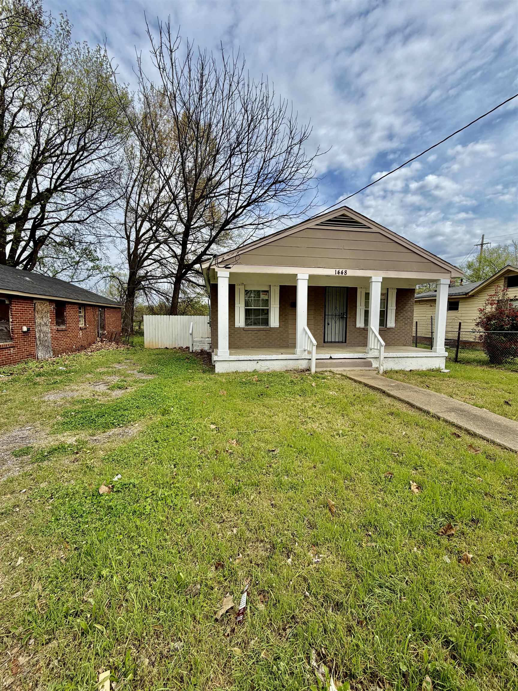 a front view of house with yard and green space