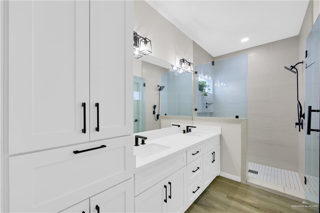 2514 Yarrow Street Mission, TX 78574 - Photo 11 of 22 Full bath with double vanity, a shower stall, light wood-type flooring, and recessed lighting