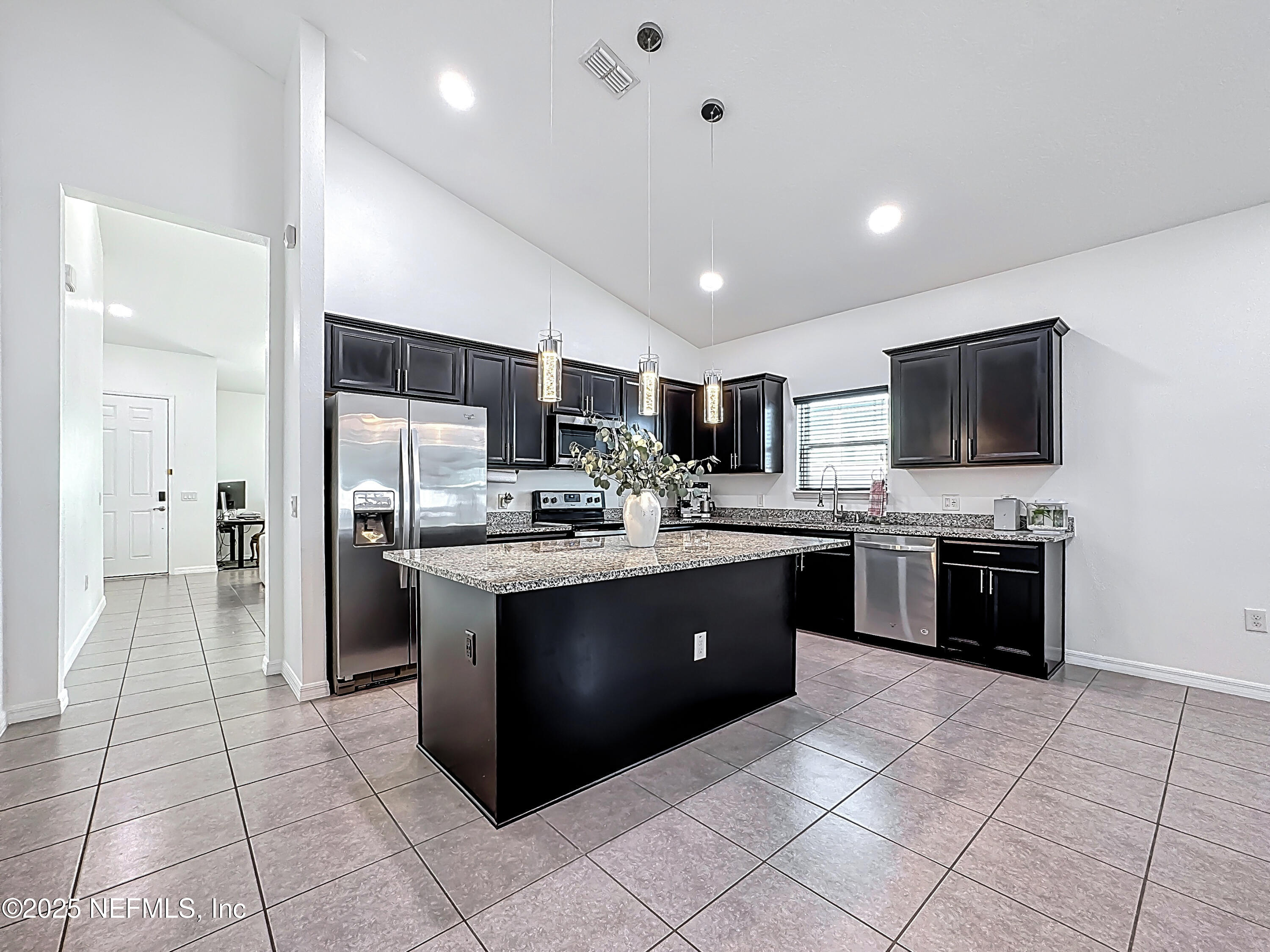 3473 Middlebrook Place St. Cloud, FL 34773 - Photo 11 of 32 a large kitchen with a large counter top stainless steel appliances and cabinets