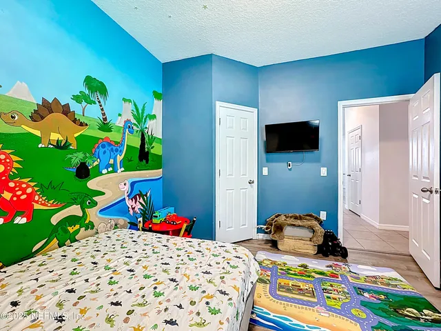 a bedroom with a bed and a dresser