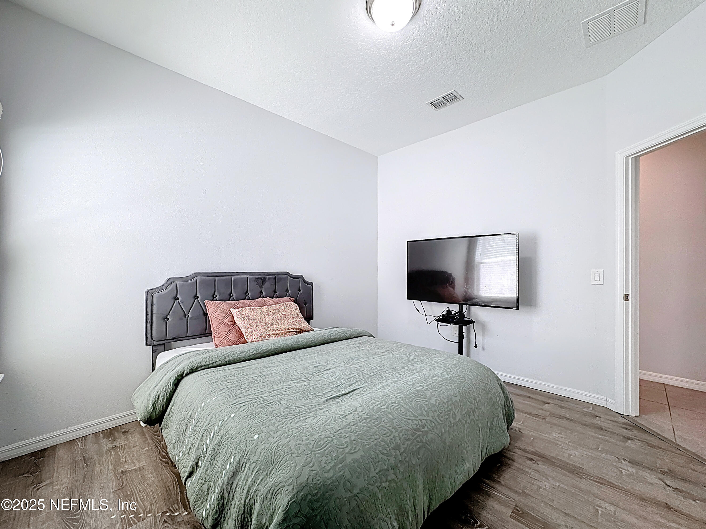 3473 Middlebrook Place St. Cloud, FL 34773 - Photo 14 of 32 a bedroom with a bed and a flat screen tv