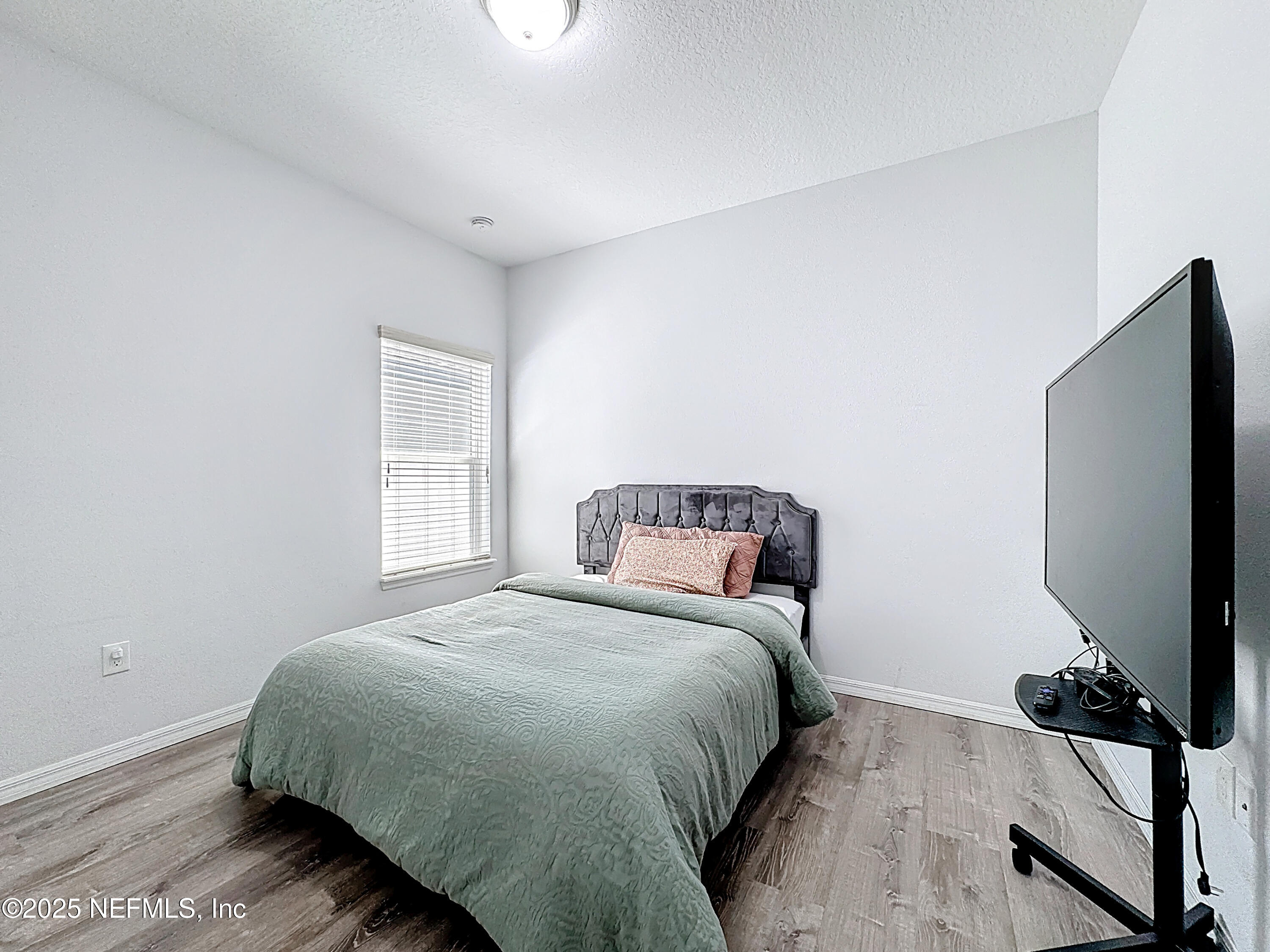3473 Middlebrook Place St. Cloud, FL 34773 - Photo 15 of 32 a bedroom with a bed tv and a window