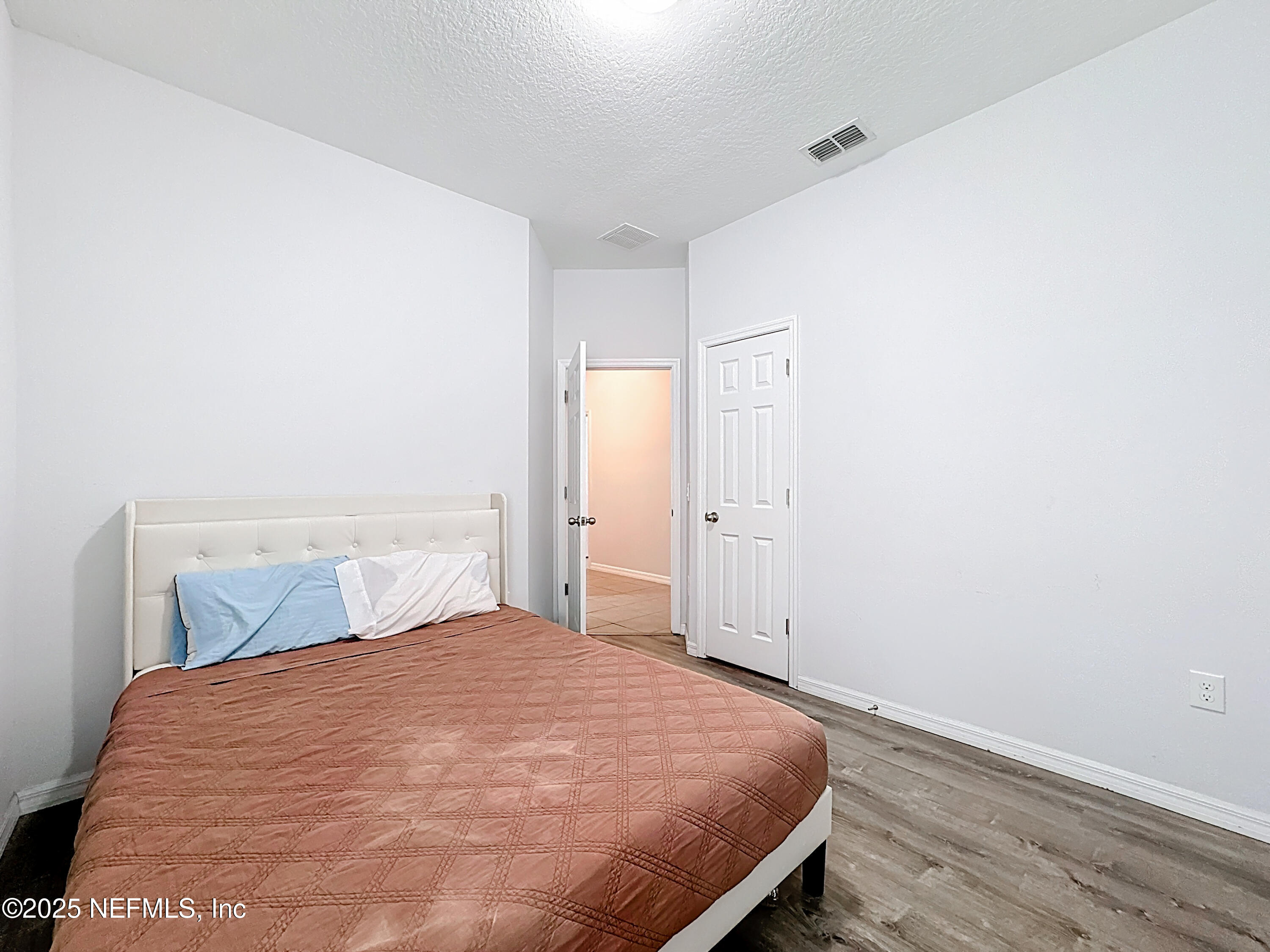 3473 Middlebrook Place St. Cloud, FL 34773 - Photo 16 of 32 a bedroom with a bed and wooden floor