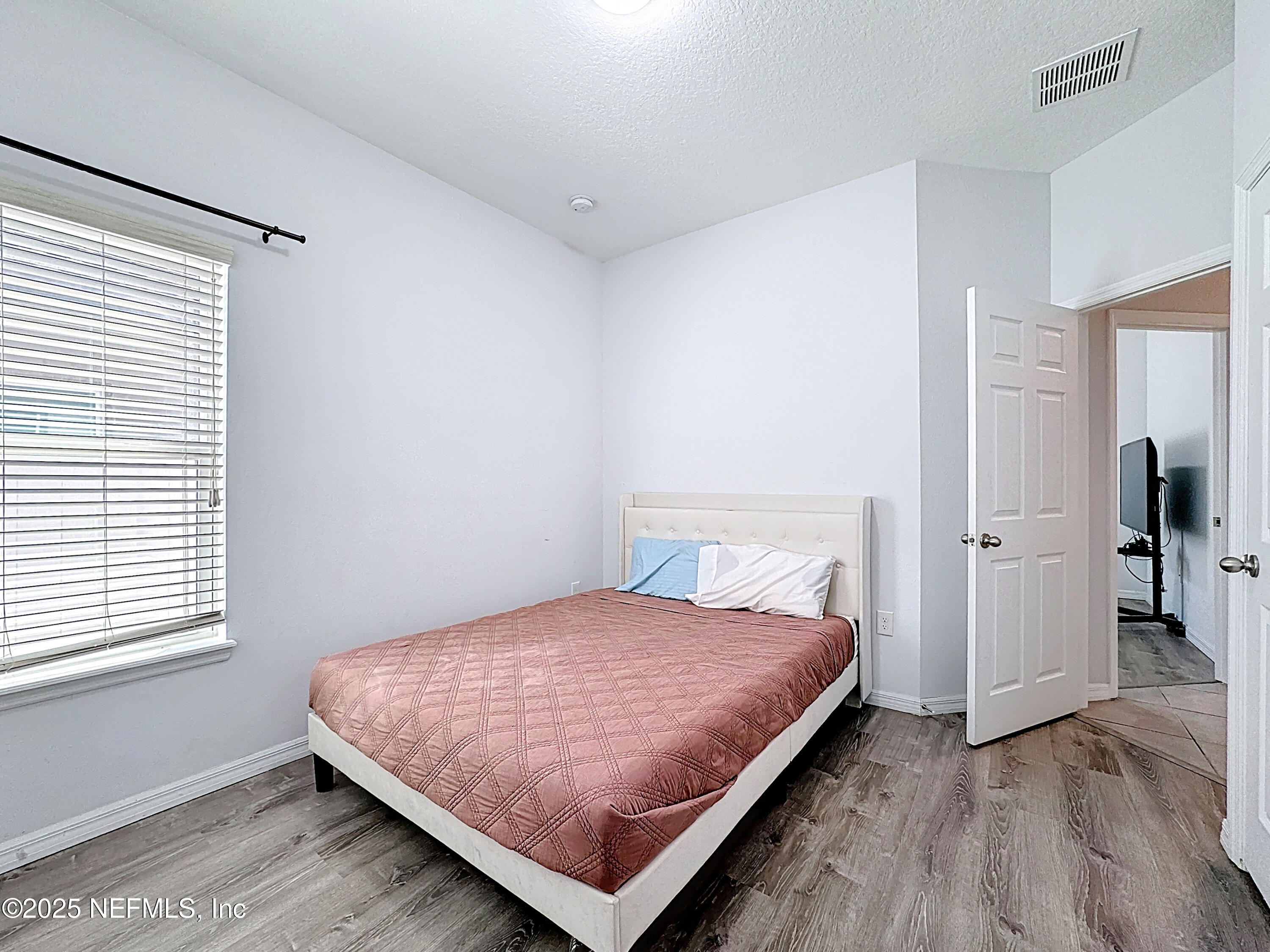 3473 Middlebrook Place St. Cloud, FL 34773 - Photo 17 of 32 a bedroom with a bed and wooden floor