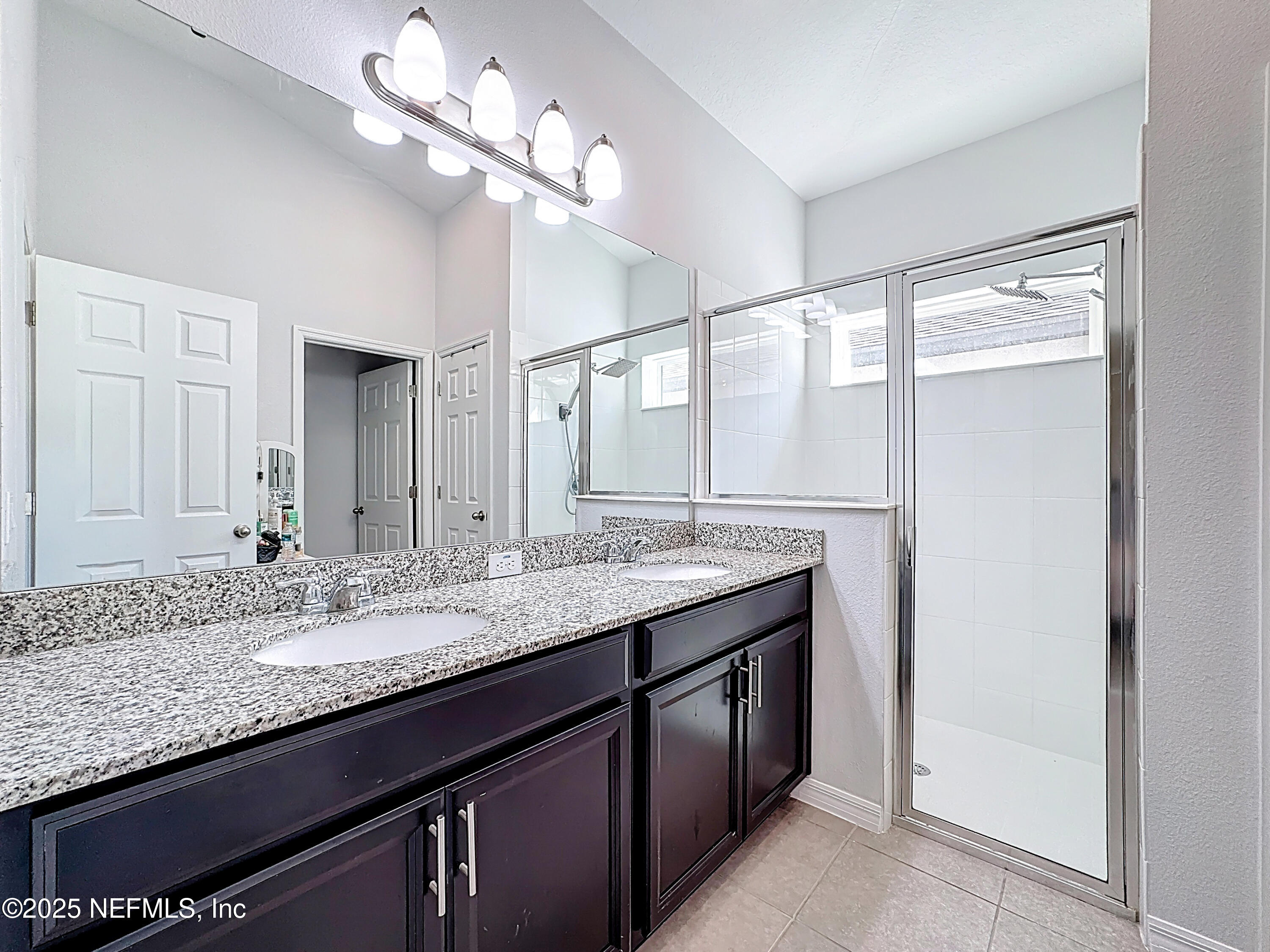 3473 Middlebrook Place St. Cloud, FL 34773 - Photo 21 of 32 a bathroom with a granite countertop sink and a mirror