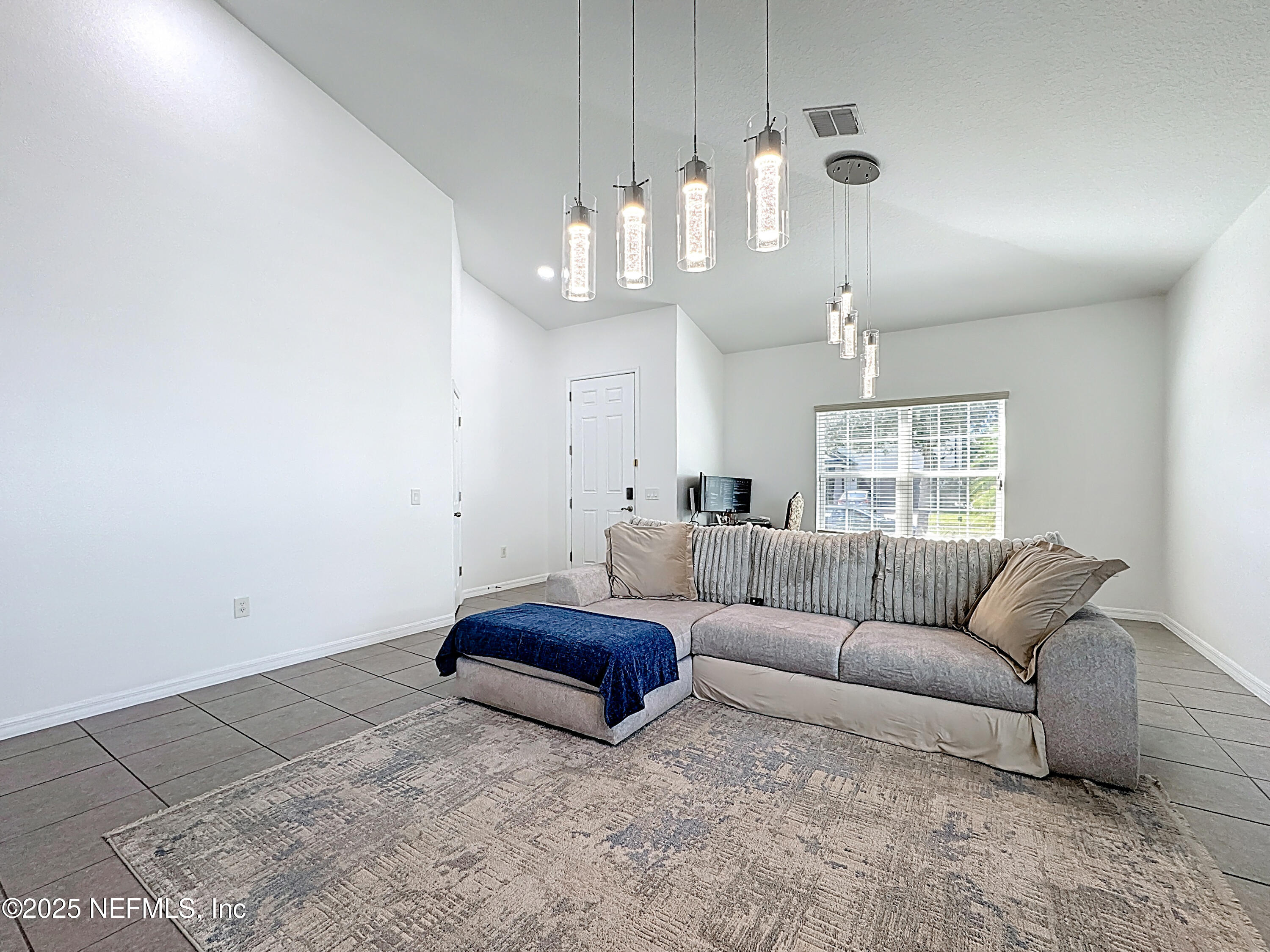3473 Middlebrook Place St. Cloud, FL 34773 - Photo 5 of 32 a living room with furniture and a chandelier