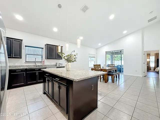 a kitchen with lots of counter top space appliances and cabinets