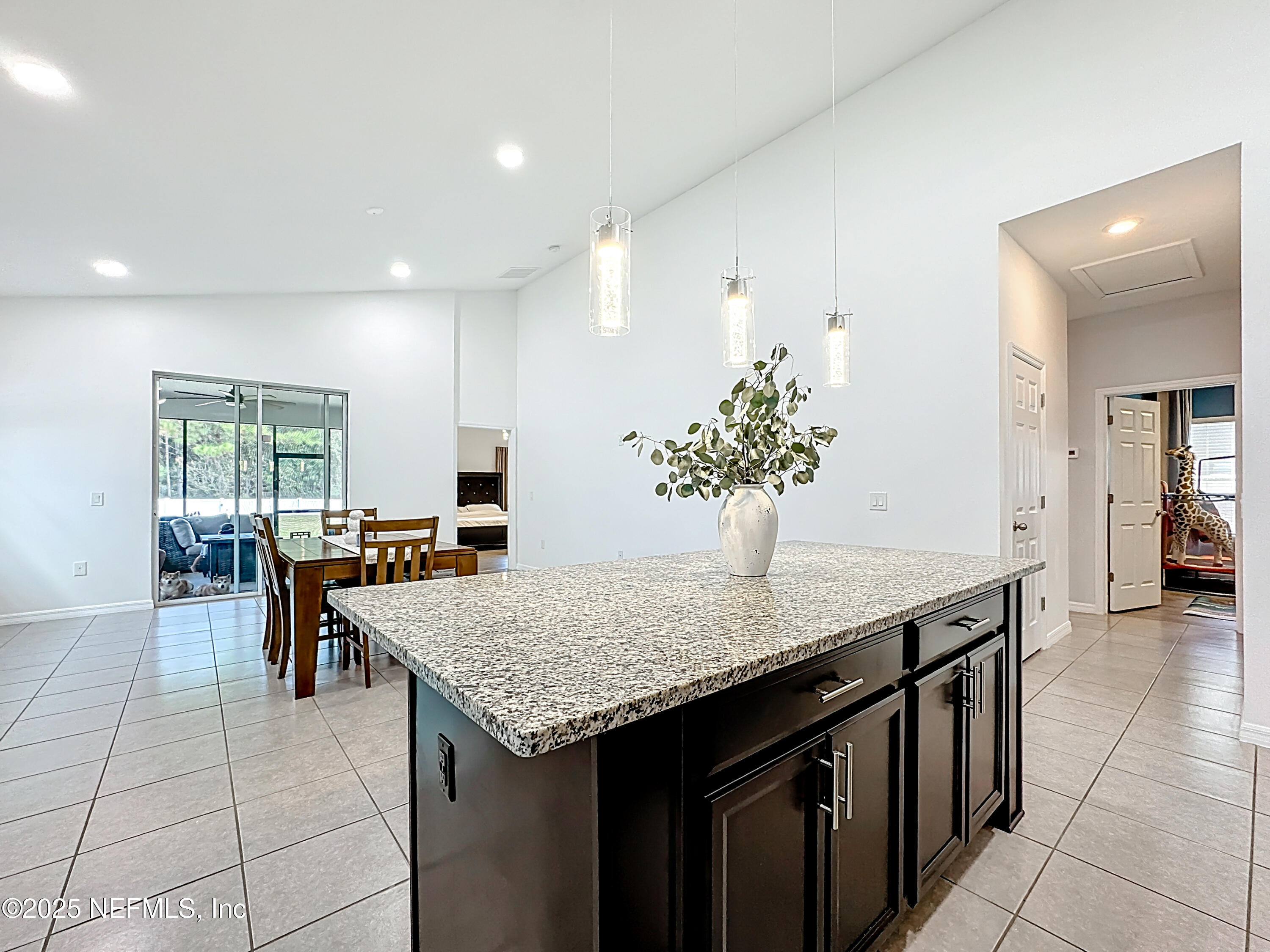 3473 Middlebrook Place St. Cloud, FL 34773 - Photo 7 of 32 a kitchen with granite countertop kitchen island a sink table and chairs