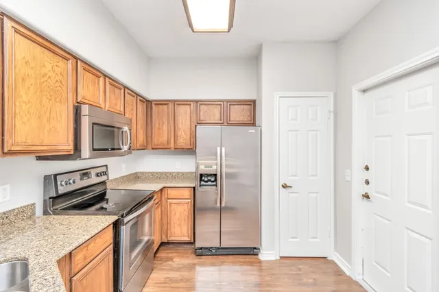 a large kitchen with kitchen island a sink stainless steel appliances and cabinets