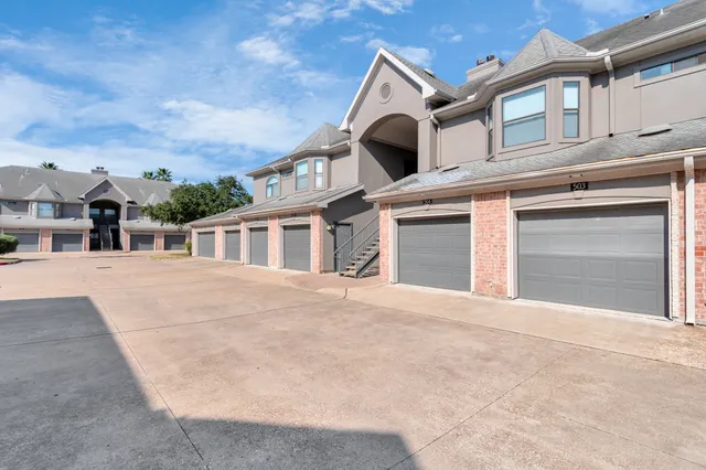 an empty room with a ceiling fan and carpet