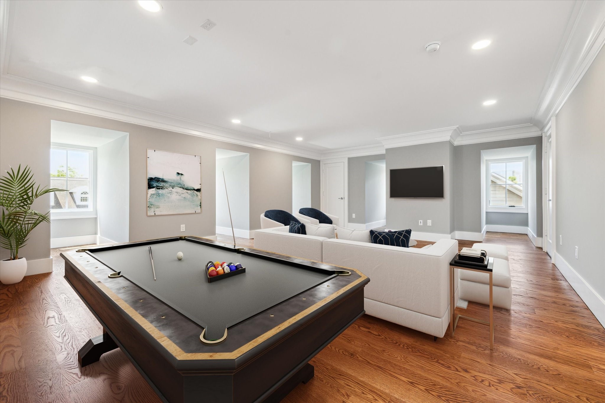 2216 Tangley Street Houston, TX 77005 - Photo 22 of 44 This 3rd floor flex/media/game room is a spacious, well-lit living area features elegant hardwood floors, a cozy seating arrangement, and a stylish pool table. Large windows bring in natural light, while modern decor and a minimalist design create a welcoming atmosphere. Use your own imagination for what your family would like here! This photo has been virtually staged.