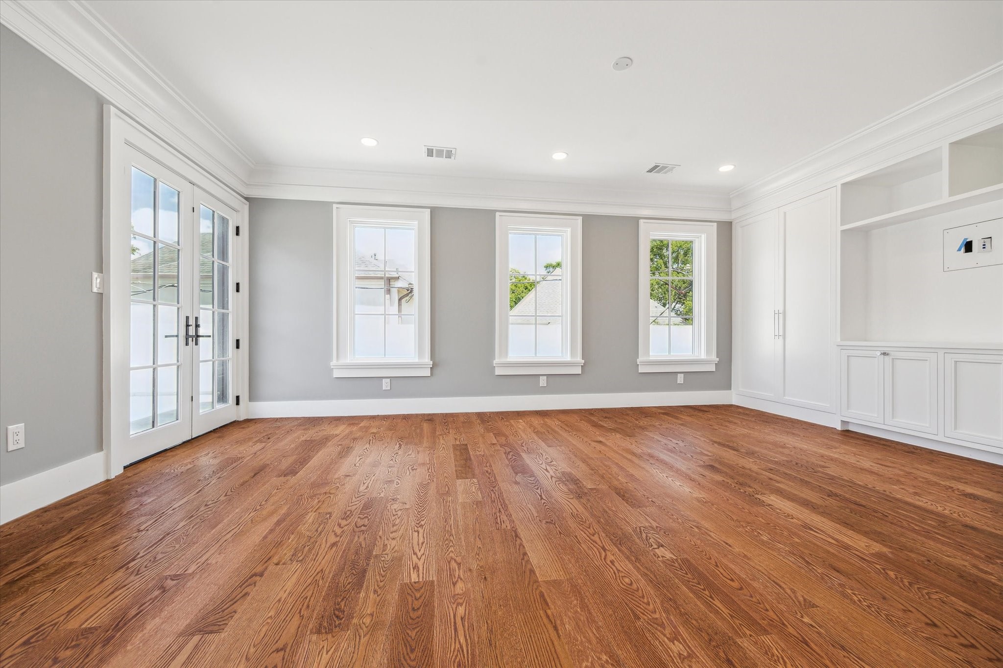 2216 Tangley Street Houston, TX 77005 - Photo 39 of 44 This secondary bedroom could also be used as a 2nd floor living area as it opens to the balcony! There is built-in shelving and modern recessed lighting, creating an inviting atmosphere.