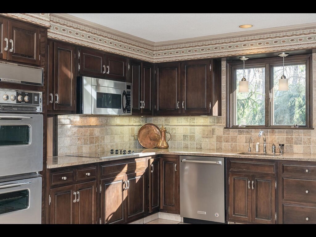 321 Ardsley Road Longmeadow, MA 01106 - Photo 23 of 42 a kitchen with kitchen island granite countertop a sink cabinets and stainless steel appliances