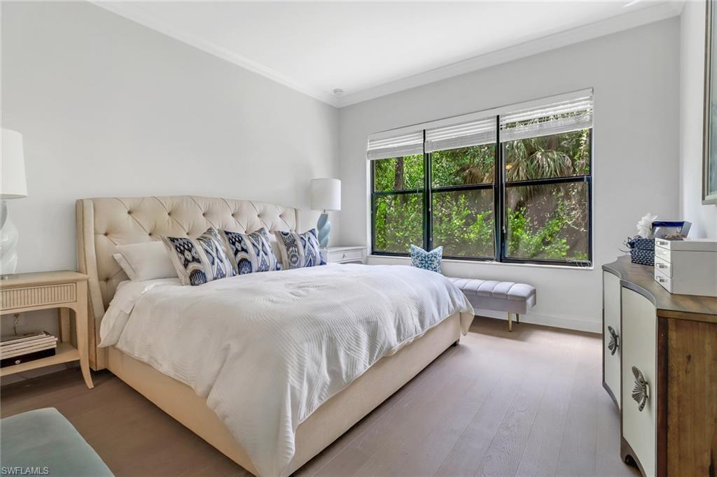 1326 Corso Palermo Court, Unit 3 Naples, FL 34105 - Photo 12 of 33 a bedroom with a large bed and a large window