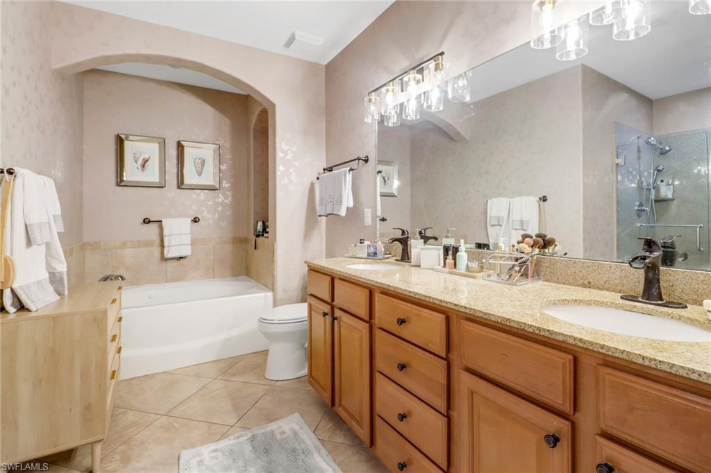 1326 Corso Palermo Court, Unit 3 Naples, FL 34105 - Photo 15 of 33 a bathroom with a tub a sink and mirror