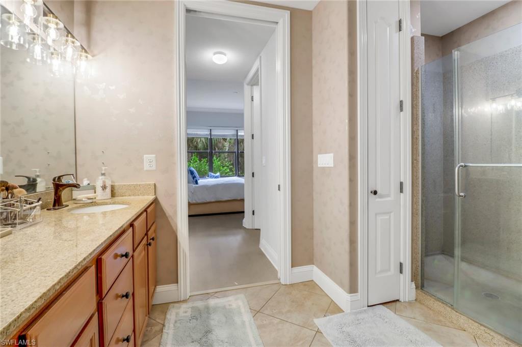 1326 Corso Palermo Court, Unit 3 Naples, FL 34105 - Photo 16 of 33 a bathroom with a sink and a mirror