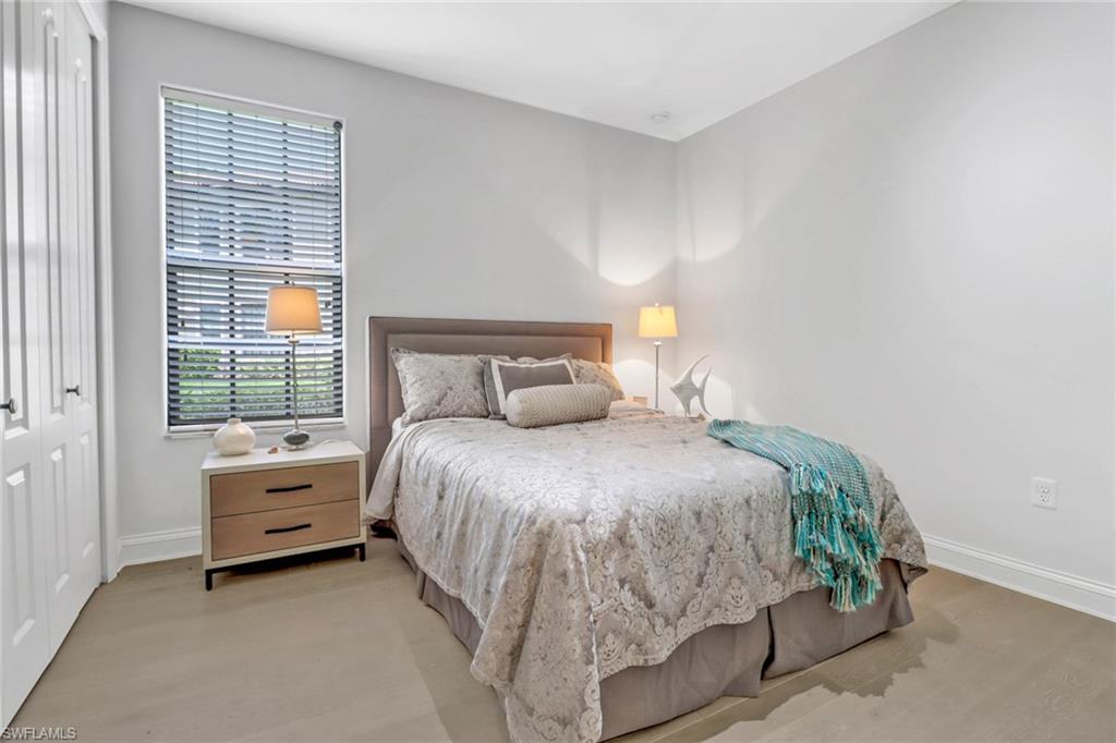 1326 Corso Palermo Court, Unit 3 Naples, FL 34105 - Photo 17 of 33 a bedroom with a bed and a window