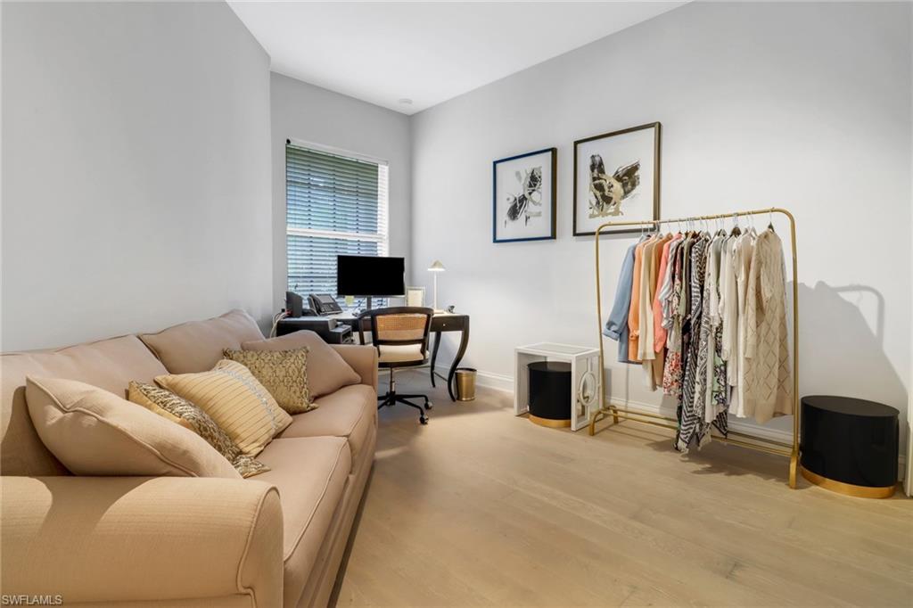1326 Corso Palermo Court, Unit 3 Naples, FL 34105 - Photo 20 of 33 a living room with furniture a flat screen tv and a fireplace