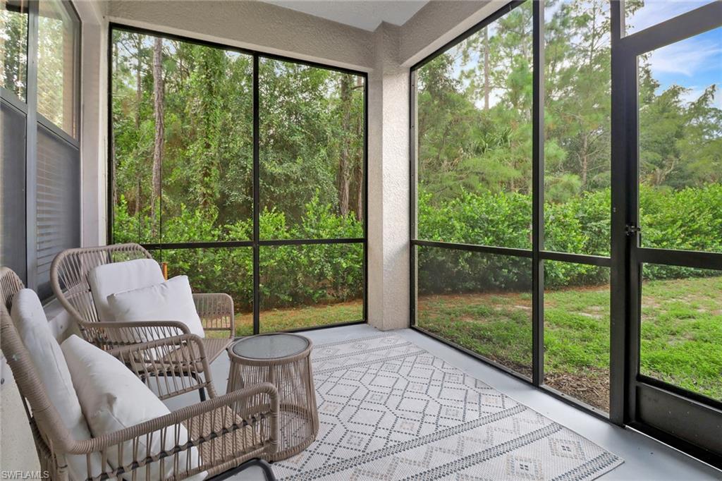 1326 Corso Palermo Court, Unit 3 Naples, FL 34105 - Photo 22 of 33 a living room with furniture and a floor to ceiling window