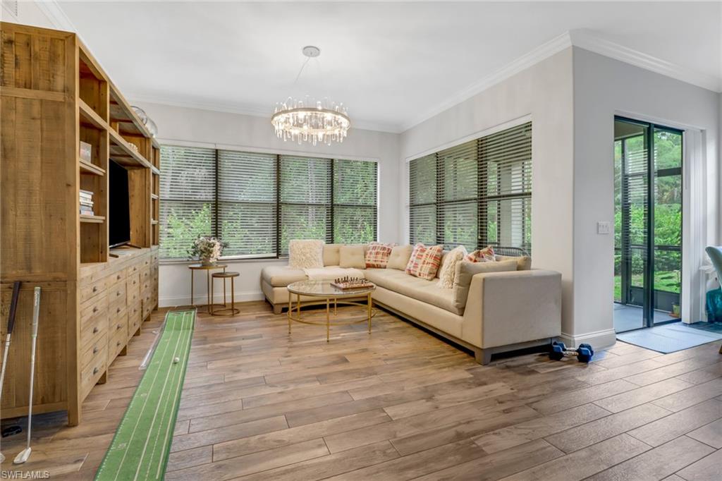 1326 Corso Palermo Court, Unit 3 Naples, FL 34105 - Photo 4 of 33 a living room with furniture floor to ceiling window and wooden floor