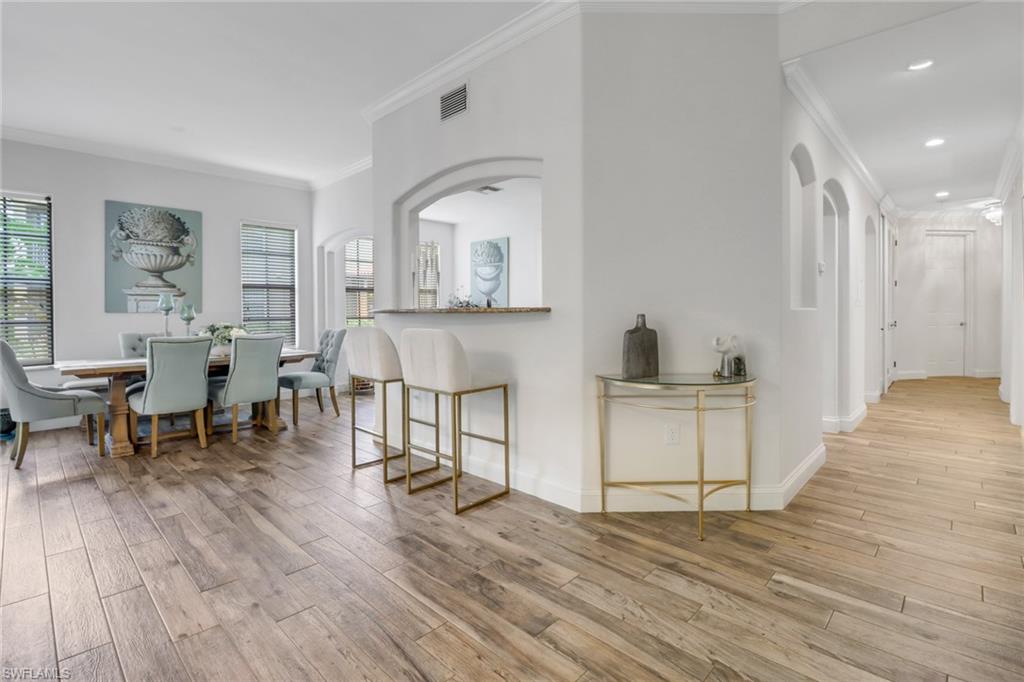 1326 Corso Palermo Court, Unit 3 Naples, FL 34105 - Photo 5 of 33 a living room with furniture and wooden floor
