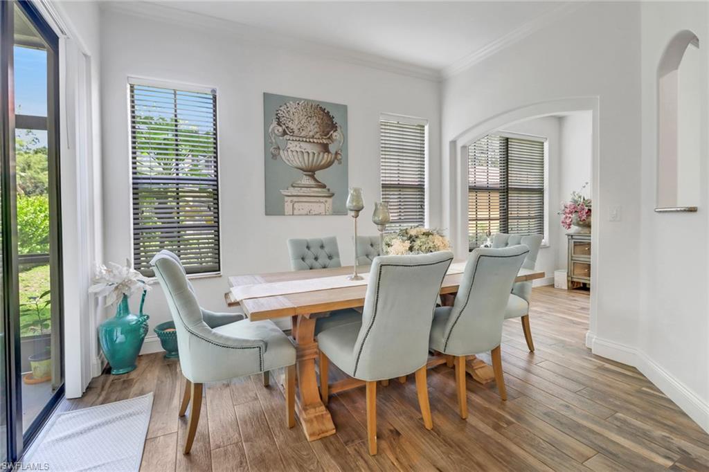 1326 Corso Palermo Court, Unit 3 Naples, FL 34105 - Photo 6 of 33 a dining room with furniture a rug and wooden floor
