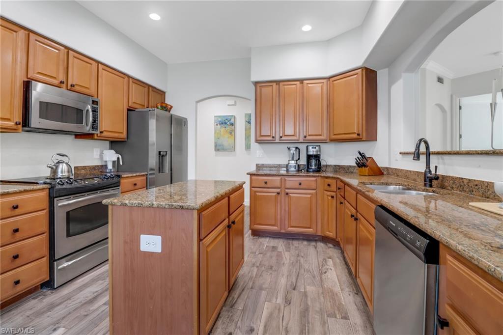 1326 Corso Palermo Court, Unit 3 Naples, FL 34105 - Photo 9 of 33 a kitchen with stainless steel appliances granite countertop a stove a sink dishwasher a refrigerator and a oven