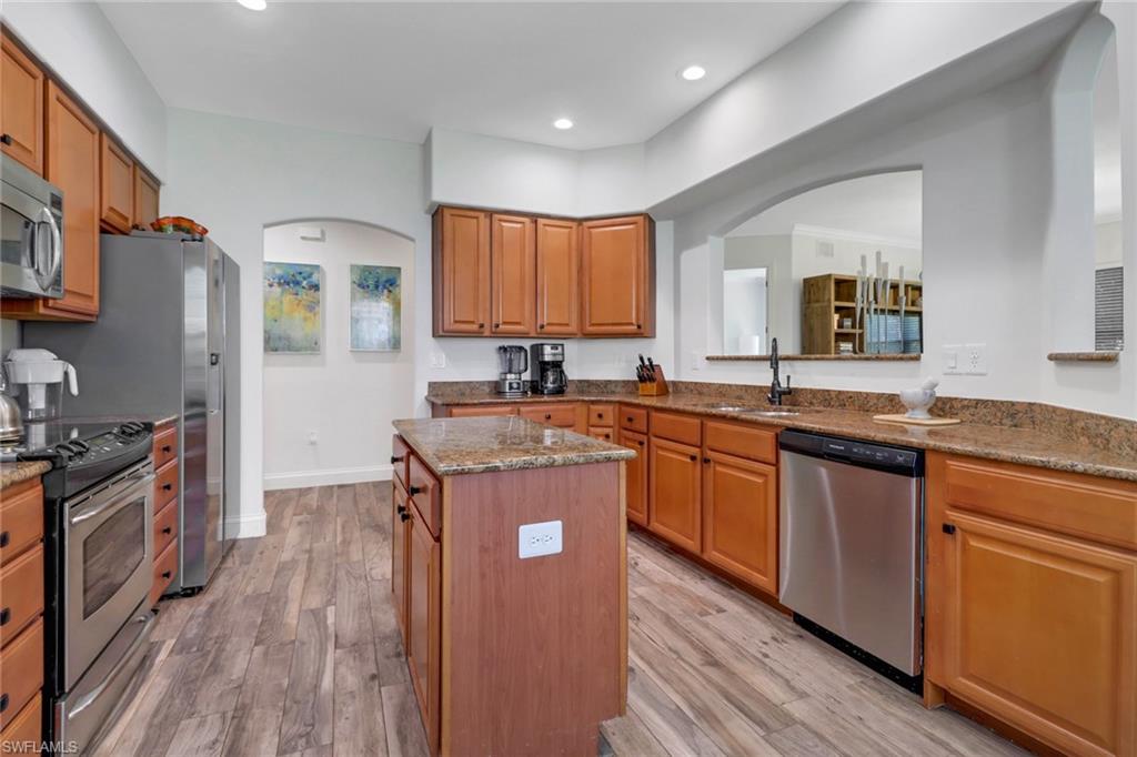 1326 Corso Palermo Court, Unit 3 Naples, FL 34105 - Photo 10 of 33 a kitchen with granite countertop a stove top oven a sink dishwasher and a refrigerator