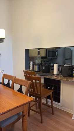 a view of a dining room with furniture and wooden floor