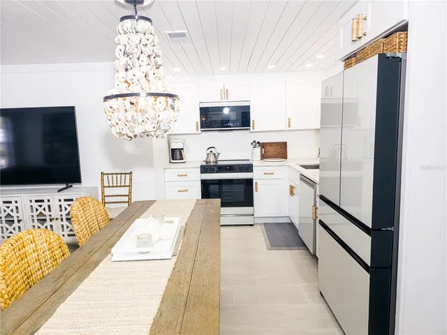 a kitchen with stainless steel appliances a microwave a stove and refrigerator